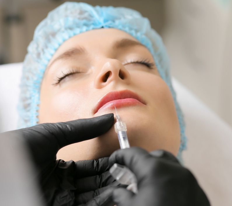 woman sitting in chair being give botox injection 1