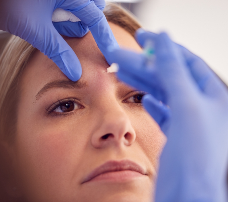 woman sitting in chair being give botox injection 2023 11 27 05 31 18 utc