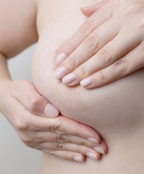 woman hand checking lumps on her breast for signs 2023 11 27 05 10 46 utc
